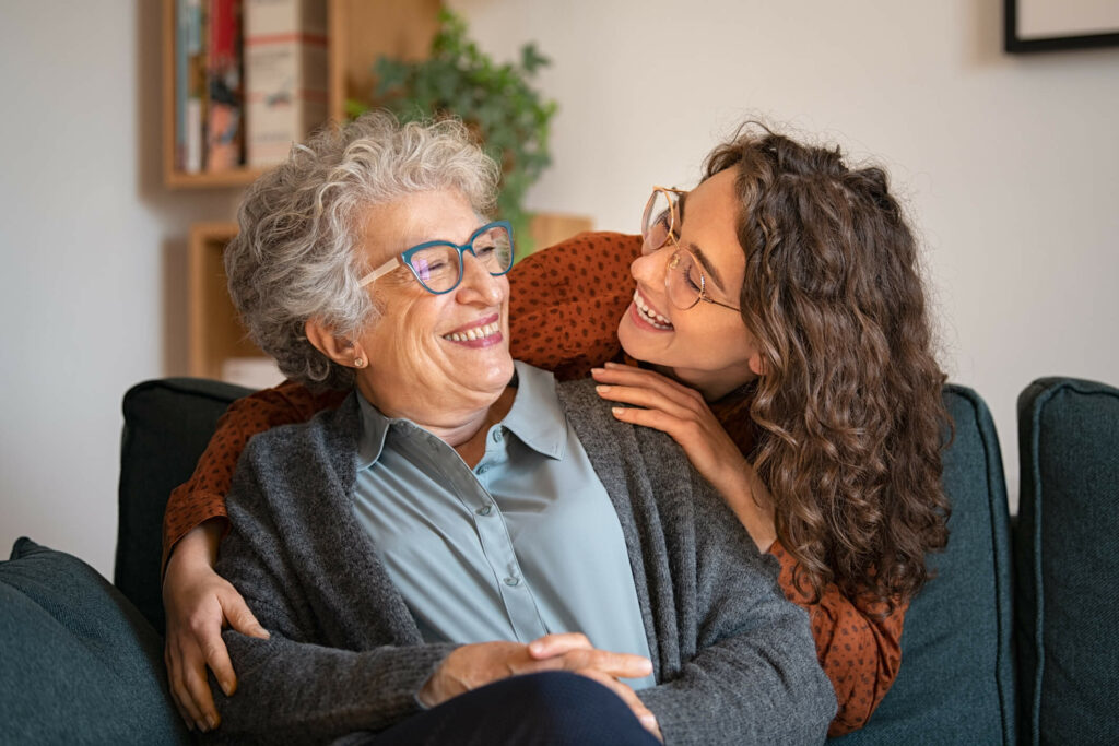 Mother and daughter embracing and smiling