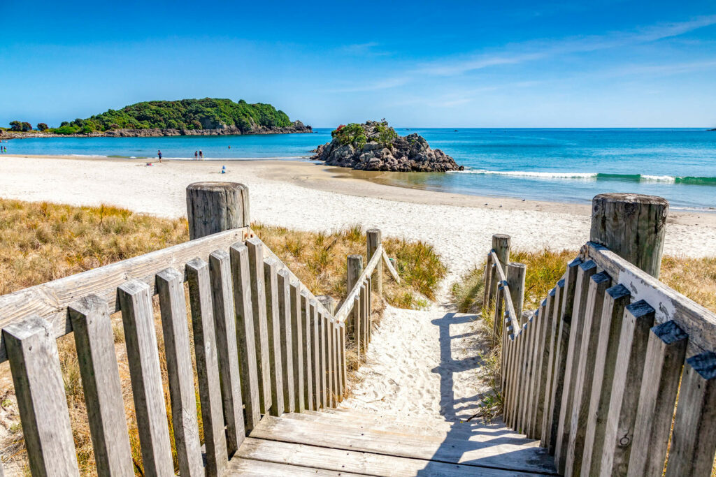 Sunny beach with steps down to sand