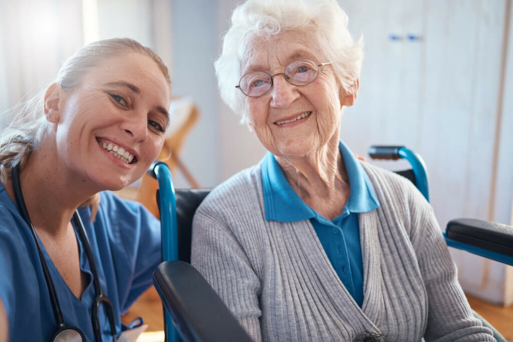 Elderly lady smiling with nurse.